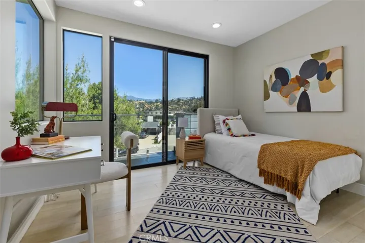 Light-filled bedroom that highlights the home's "treehouse" feel and connection to the canyon.