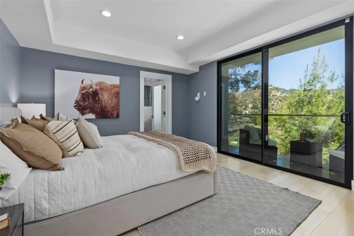 Serene bedroom that emphasizes the home's connection to the outdoors.