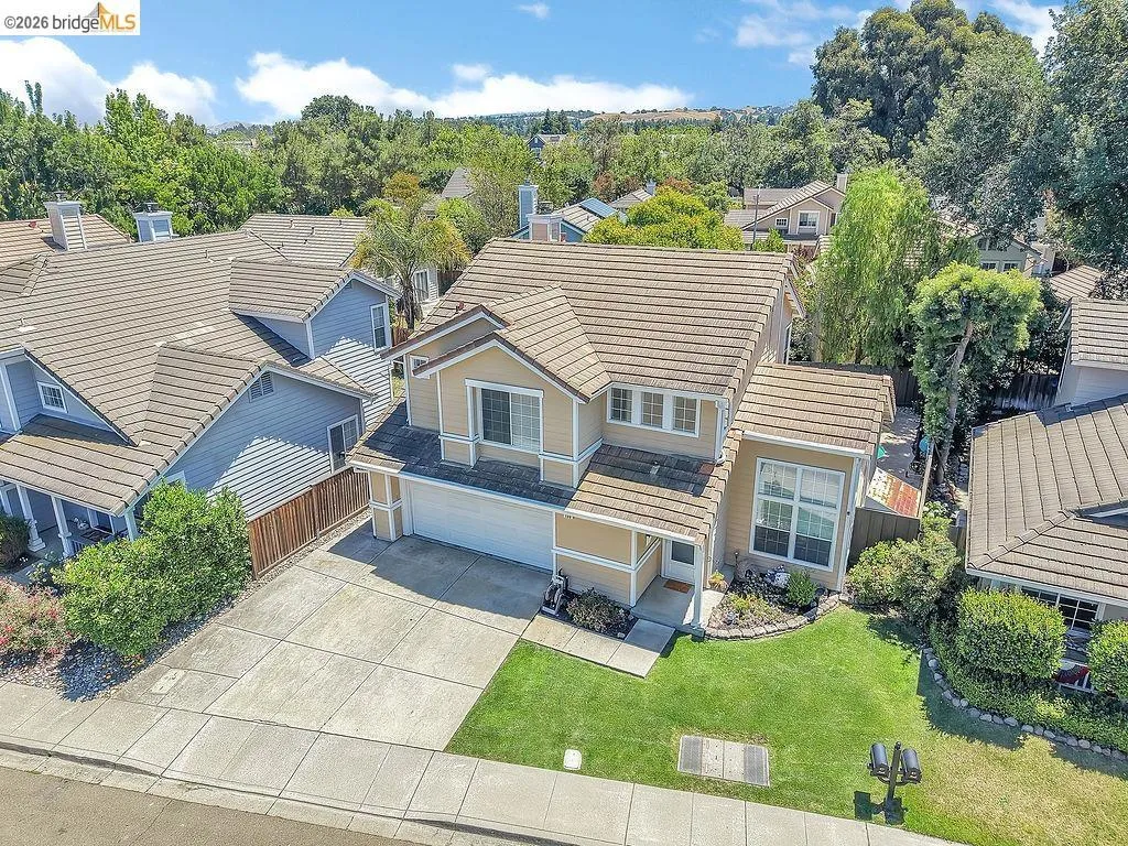 Two-story residence with a tan exterior and brown tile roof