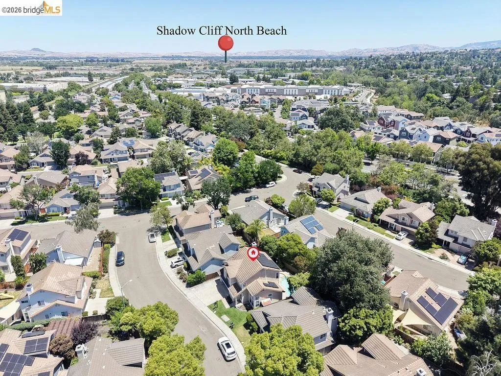 Aerial perspective of a residential neighborhood featuring numerous detached homes with varied architectural styles
