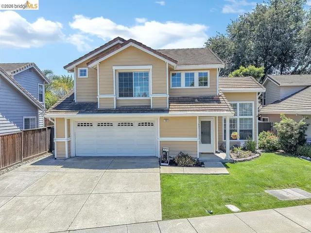 Two-story residence featuring a neutral-toned exterior with white trim