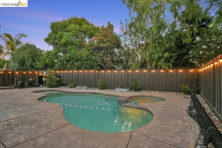 Freeform swimming pool and spa with concrete decking