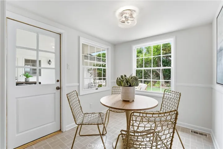 Breakfast nook with lots of light and exterior door to backyard patio.