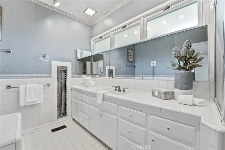 Primary bathroom with vanity, tub and separate shower.