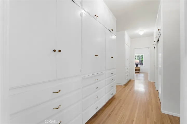 Hallway full of storage cabinets and closet.