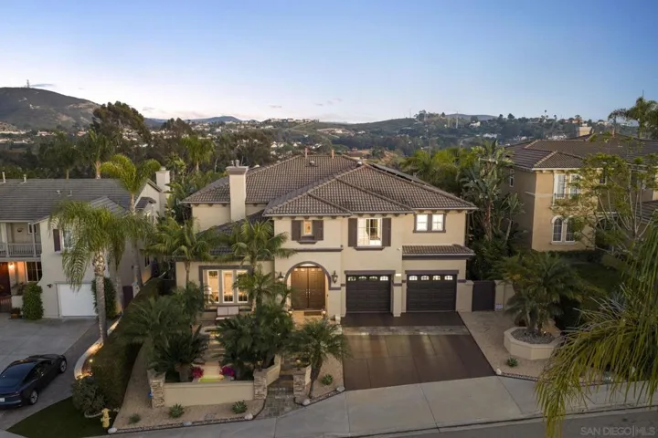 Elevated hillside living begins with a striking residence framed by lush tropical landscaping and sweeping canyon, hill, and mountain views. Grand curb appeal, a two-car garage, and an inviting arrival set the tone for the lifestyle within.