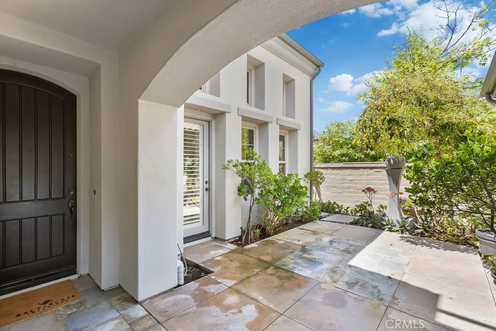 Gated courtyard leads to detached casita.