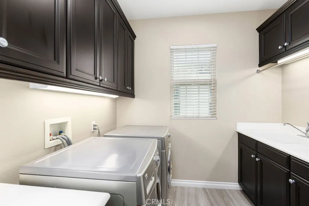Upstairs laundry with utility sink.