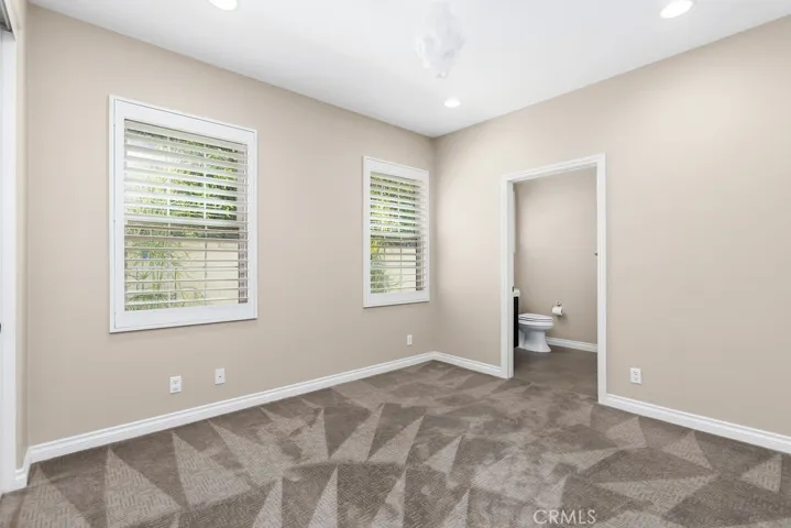Main level bedroom with ensuite bath has a walk in shower.