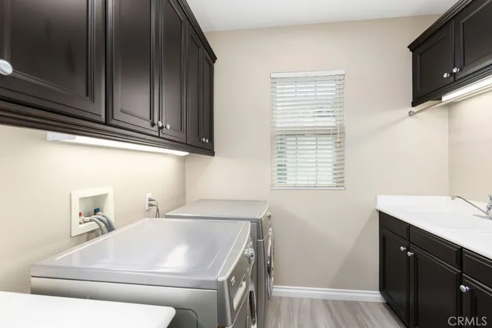 Upstairs laundry with utility sink.