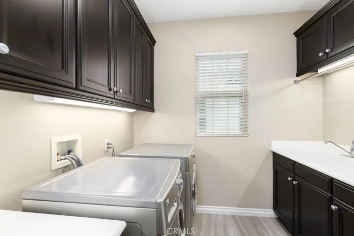 Upstairs laundry with utility sink.