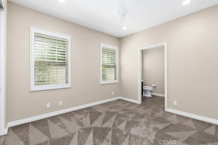 Main level bedroom with ensuite bath has a walk in shower.