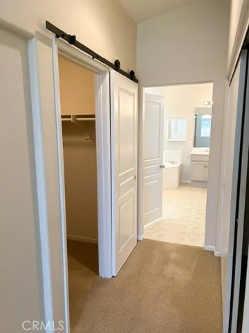 hallway leading to the primary bathroom