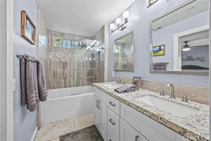 Gorgeous primary ensuite with herringbone custom tile work.