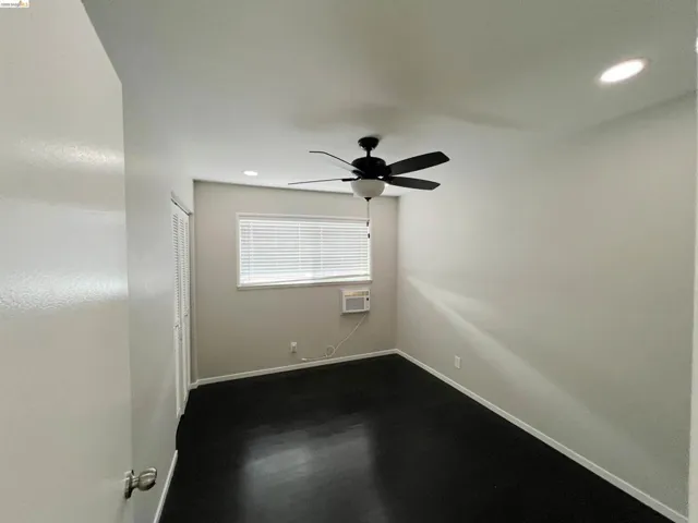 Empty room with recessed lighting, ceiling fan, and dark wood-style floors