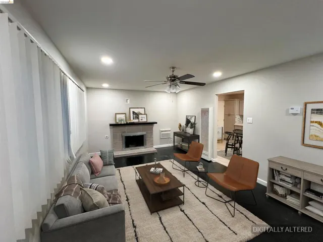 Living area featuring ceiling fan, a tiled fireplace, recessed lighting, and a heating unit