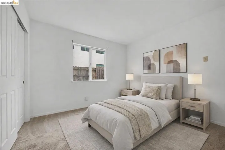 Bedroom featuring light carpet and a closet