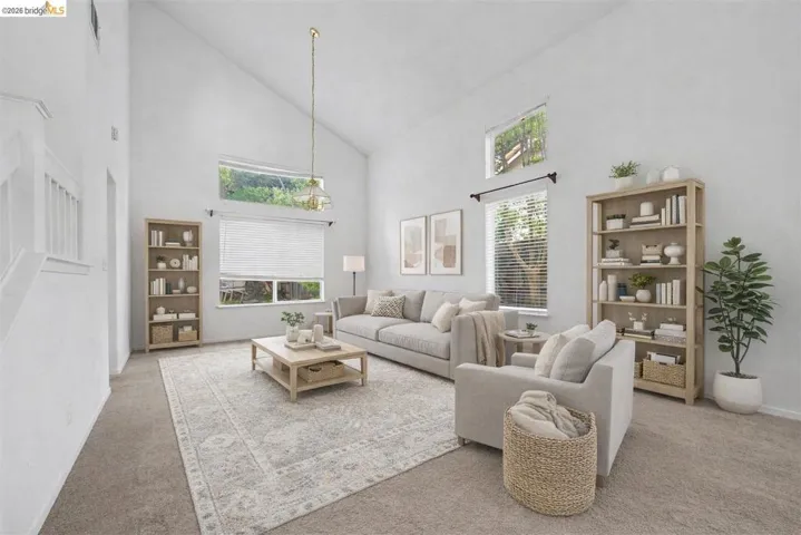 Carpeted living room with lofted ceiling