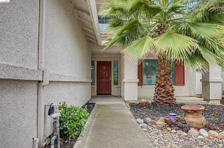 Entrance to property featuring stucco siding and a porch