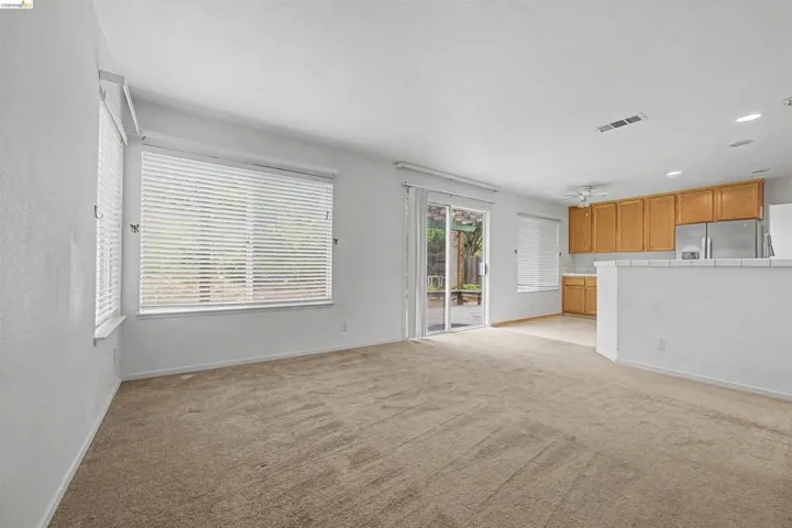 Unfurnished living room with recessed lighting and light carpet