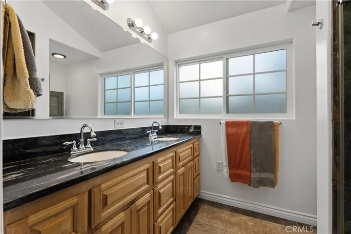 Primary remodeled bathroom with dual sinks.
