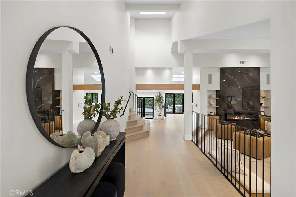Brightly lit entry with high ceilings and natural flow