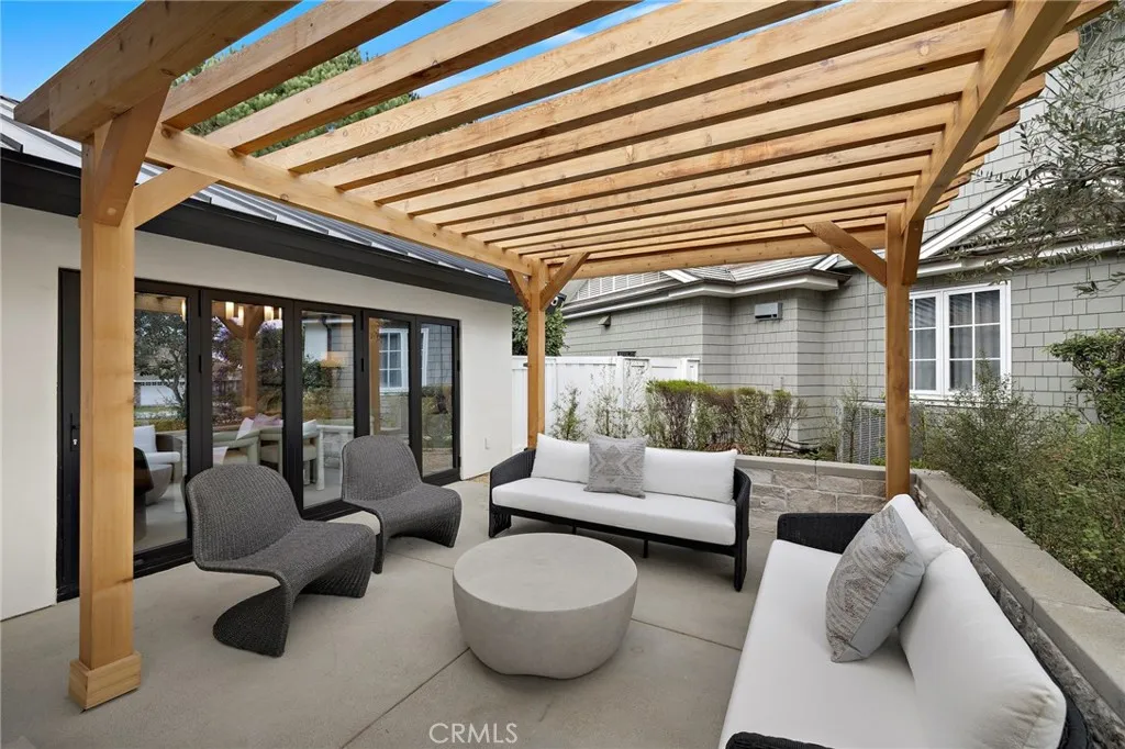 Gorgeous view of front patio with pergola