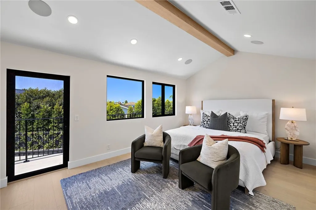 Primary bedroom with private balcony with mountain views