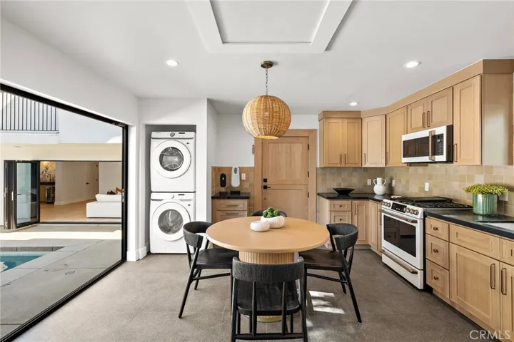 ADU Full laundry, full kitchen with bi-fold doors to pool and oak dutch entry door.