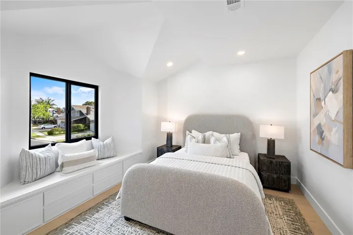 One of four of the upstairs bedrooms with custom bench window seat with storage and beautiful light