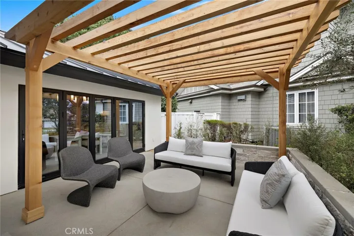 Gorgeous view of front patio with pergola