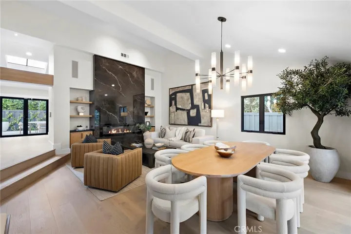 A floor-to-ceiling black marble slab fireplace specifically designed and positioned as a striking focal point to enhance indoor/outdoor living and entertaining