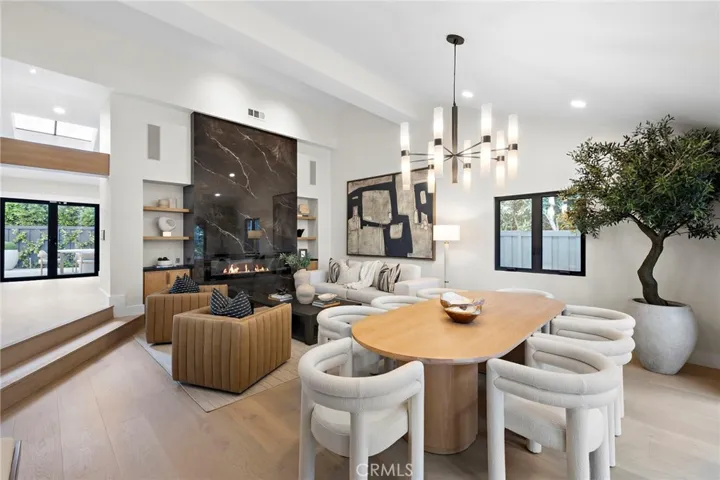 A floor-to-ceiling black marble slab fireplace specifically designed and positioned as a striking focal point to enhance indoor/outdoor living and entertaining