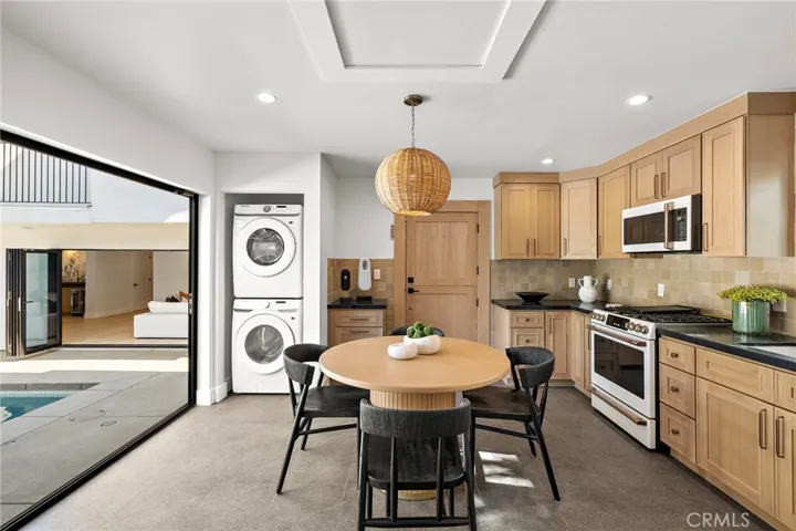 ADU Full laundry, full kitchen with bi-fold doors to pool and oak dutch entry door.