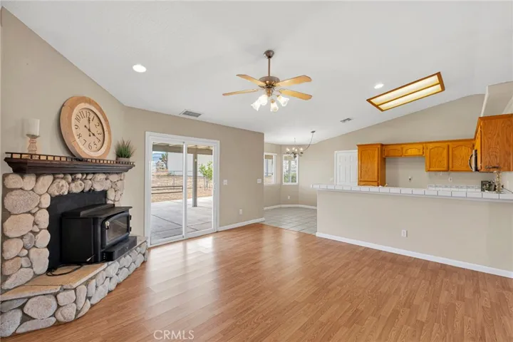 Family room with cozy rock fireplace with real wood burning fireplace.