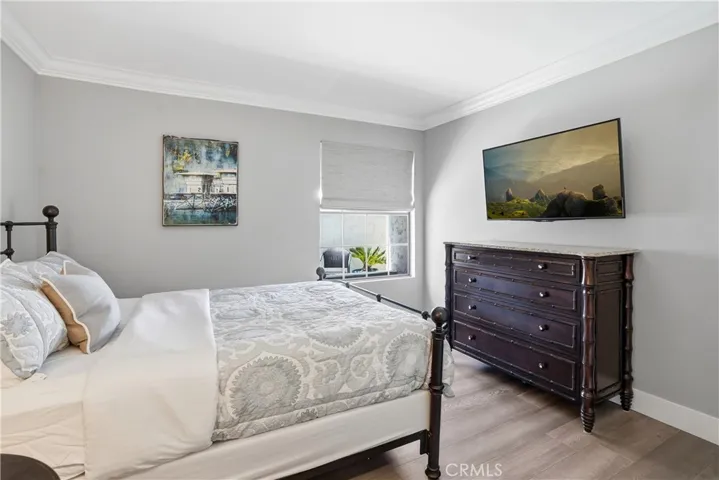 Well-appointed bedroom featuring natural light, neutral tones, and a functional layout. Offers a comfortable and versatile space ideal for guests, family, or a home office.