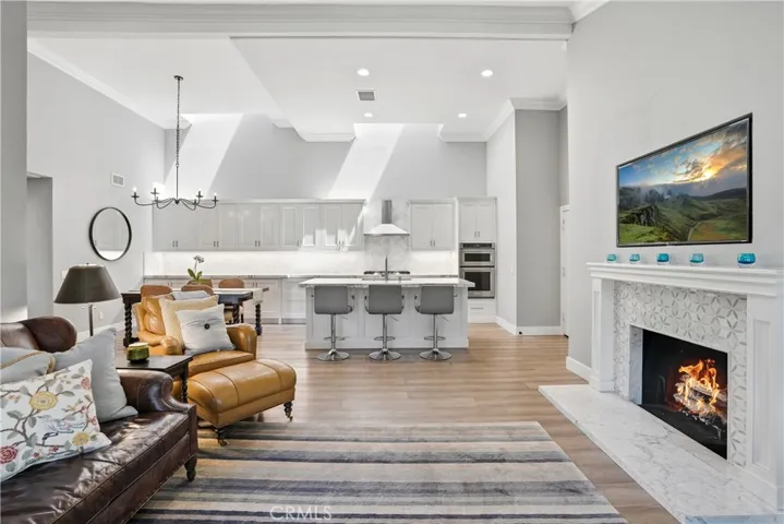 Seamless open-concept layout connecting the living room to a beautifully updated kitchen. Soaring ceilings, recessed lighting, and expansive sightlines create an airy environment ideal for modern living and effortless entertaining.