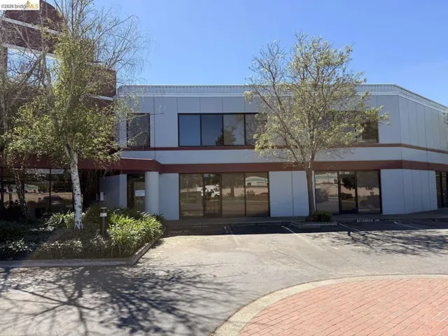 view of commercial property featuring uncovered parking