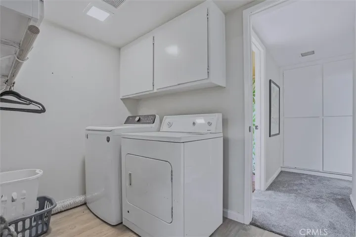 Separate laundry room with new vinyl plank flooring.  Lots of storage on both side and both gas and electric hookups