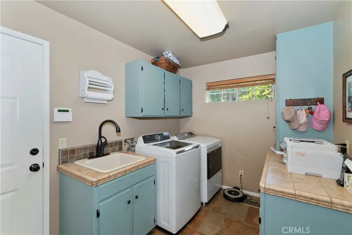Laundry w/utility sink/loads of storage.