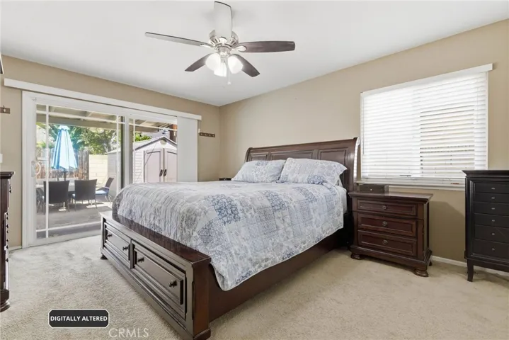 Primary bedroom w/access to relaxing Backyard