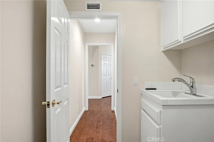 Downstairs laundry room with sink