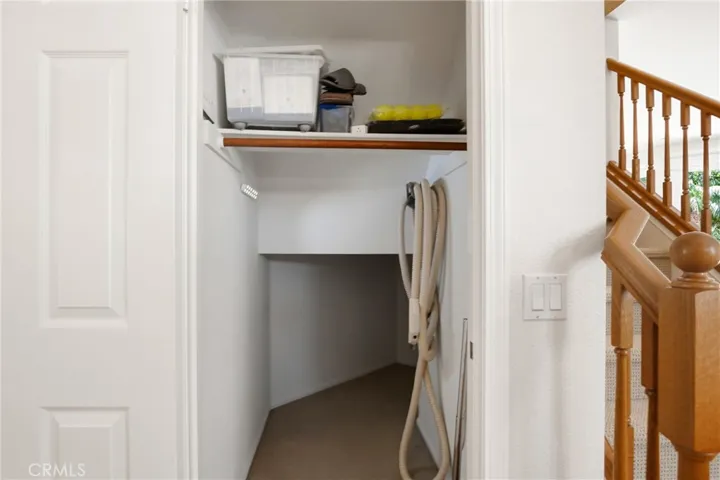 Front coat closet that extends under stairs