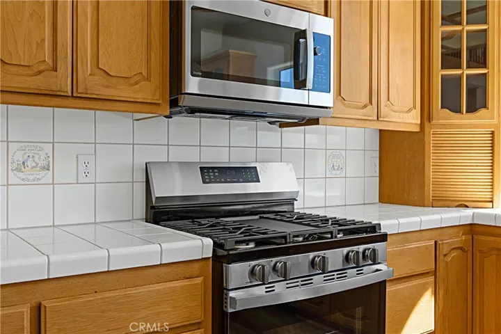 GE Profile Microwave and Stove/Oven combo.  Appliance garage to the right.