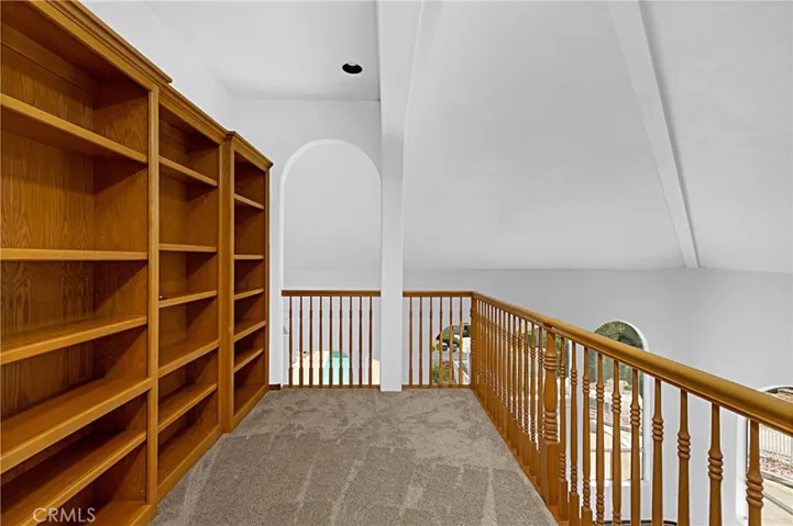 Upstairs loft area has beautiful bookshelves for your library!