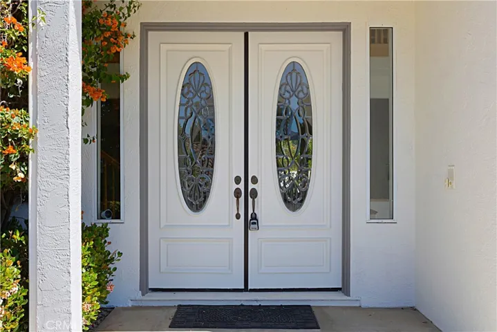 Double door entry with custom leaded glass inserts and sidelights