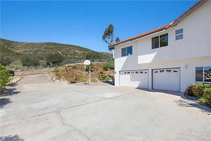 Driveway toward back of property and 3 car garage.