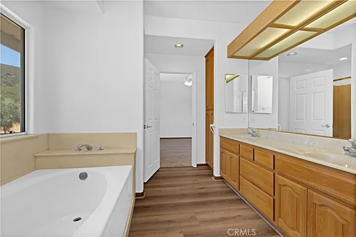 Photo of the upstairs guest bathroom. Includes shower, dual bathroom and bathtub.