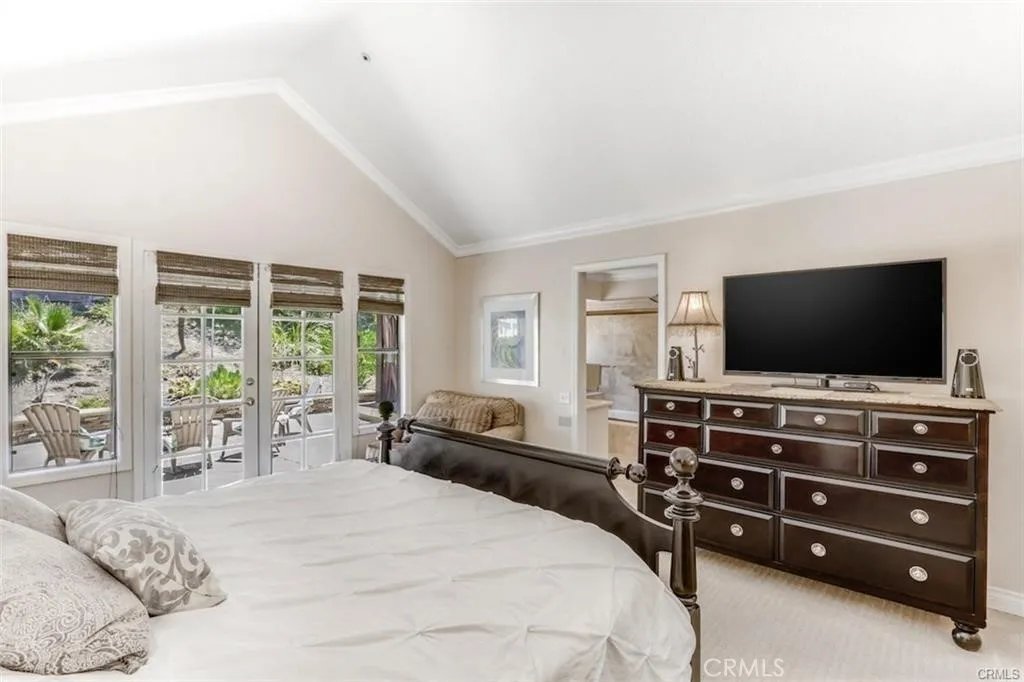 Expansive primary bedroom with pool view Expansive primary bedroom with pool view