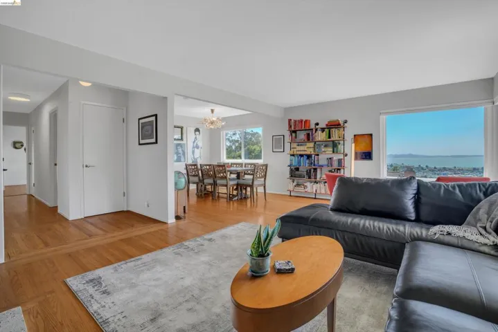 Living room with light wood-style floors and hanging lights